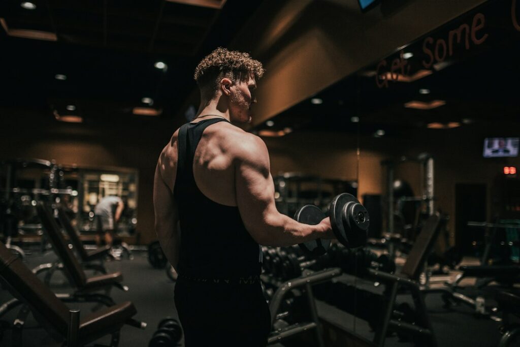 Concentric vs eccentric exercise with an athlete holding a dumbbell.
