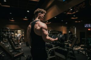 Concentric vs eccentric exercise with an athlete holding a dumbbell.