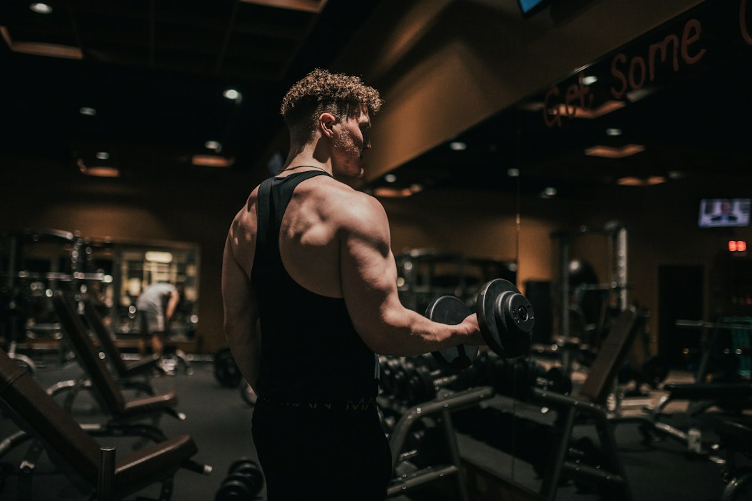 Concentric vs eccentric exercise with an athlete holding a dumbbell.