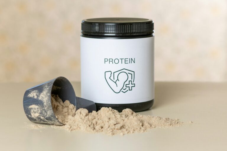 Protein powder and scoop, illustrating drinking protein before bed.